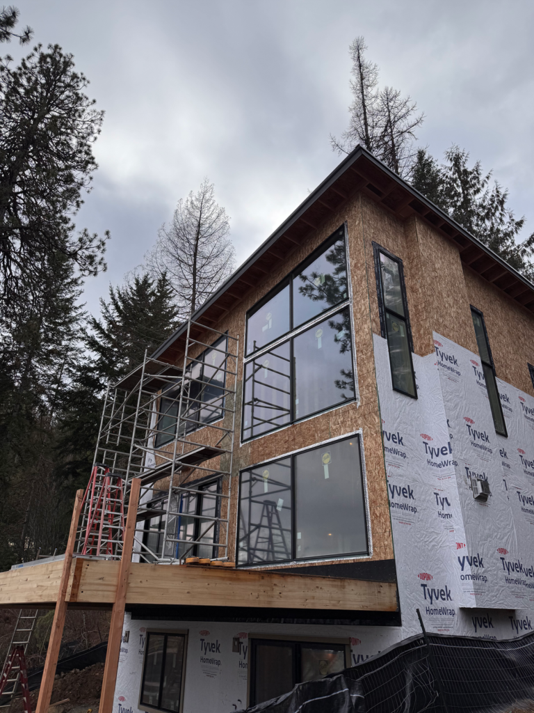 Multi-story Pella window wall installed by Mbuilt in Spokane